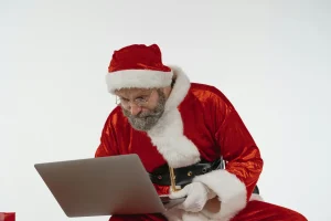 Santa looking at a laptop